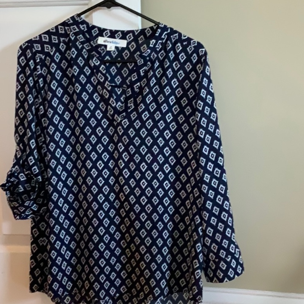 Pretty blue blouse with button sleeve if desired. Polyester,machine washable
